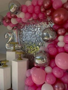 there are balloons and disco balls on the wall in front of this birthday party backdrop