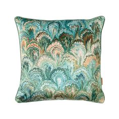 a green and blue pillow with an abstract design