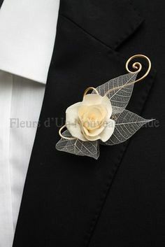 a close up of a suit with a flower on it's lapel pin