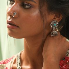 a close up of a person wearing jewelry