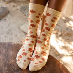 A flower is as beautiful as it is resilient and powerful. Wear these beige and orange socks with a butterfly embroidery as a reminder that everyone deserves the opportunity to grow where they are planted. Fairtrade, GOTS, and Vegan Certified Terry padding for comfort Machine wash cold. Do not Bleach. Tumble dry Low. Do not Iron. 75% Fairtrade Organic Cotton, 23% Recycled Polyester, 2% Elastane Made in India Fit for US Men’s Shoe Sizes: Small (4-8), Medium (8-13), Large (13+) Fit for US Women’s S Spring Favorites, Orange Socks, Sock Collection, Organic Gifts, Floral Socks, And Justice For All, Clothing Blogs, Trust Fund, Women Writing