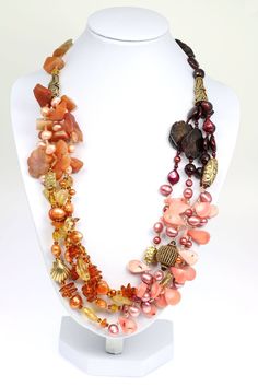 Behold the aura of beaded bliss emanating from this tri-colored Garnet, Amber, and Carnelian necklace. A cluster texture, from smooth to faceted beads of Carnelian, Citrine, Pink Coral, Garnets, and dyed Freshwater Pearls cascade throughout the necklace. Further enhanced by 24K Gold Vermeil beads, the elegant combinations of soft pastel colors are sure to bring out your flawless feminine features. Measures approximately 22 inches in length. Secures with a Vermeil Toggle Closure Gift Boxed. Garne Multicolor Carnelian Jewelry With Polished Beads, Multicolor Carnelian Beaded Jewelry, Multicolor Carnelian Necklaces With Polished Beads, Multicolor Beaded Carnelian Jewelry, Artisan Multicolor Carnelian Necklace, Carnelian Jewelry With Colorful Beads For Jewelry Making, Multicolor Carnelian Round Bead Jewelry, Multicolor Carnelian Gemstone Beads, Multicolor Carnelian Bead Jewelry