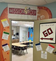 an open door to a classroom with bulletin boards on the front and back doors that read, mission poly