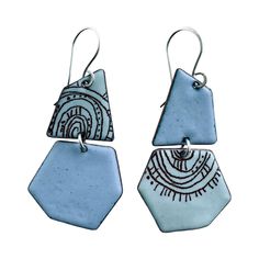 Geometric shaped earrings feature 2 beautiful shades of ocean blue. These artful enameled earrings are decorated with hand drawn decals and hang on handmade sterling silver ear wires. Modern Blue Geometric Jewelry, Modern Geometric Blue Jewelry, Turquoise Enamel Dangle Earrings, Artsy Blue Enamel Jewelry, Blue Artistic Design Drop Earrings, Handmade Blue Geometric Jewelry, Artsy Blue Nickel-free Jewelry, Artistic Blue Earrings As Gift, Artsy Nickel-free Blue Jewelry