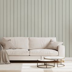 a white couch sitting next to a table on top of a hard wood floor