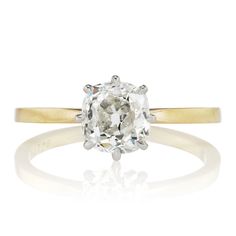 an oval cut diamond ring in yellow gold