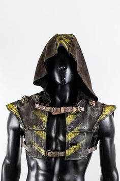 a mannequin wearing a leather hoodie with yellow and black designs on it