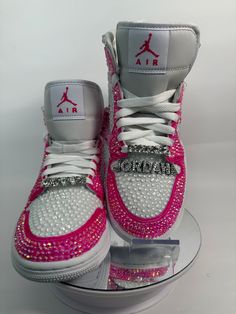 Step up your sneaker game with some fully blinged Jordan 1 mids. These shoes are a great addition for prom, a birthday, a wedding, a night on the town, or your  next event! These shoes can be customized to the colors of your choosing. Not looking for Jordan 1's? Message me with your shoe choice. I'd love to create the custom shoe of your dreams. Please note, shoe charms are not included in the listing but are available as a bonus add on. Please see my listing entitled EXTRAS to add shoe charms.  *Disclaimer We are not associated with the brand, I only hand customize the shoes using rhinestones. Rhinestone Sneakers, Jordan 1 Mids, Casual Shoes Women Sneakers, Bedazzled Shoes, Nike Shoes Women Fashion, Pretty Sneakers, Pink Nike Shoes, Custom Rhinestone, Preppy Shoes