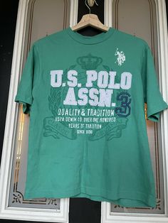 U.S. Polo ASSN USPA Denim Co. Quality Tradition T Shirt Size Medium 10/12 Boys. Green Cotton Shirt With Text Print, Vintage Cotton Shirt With Logo Print, Vintage Cotton T-shirt With Branding, Green Casual Tops With Branding, Casual Green Tops With Branding, Vintage Cotton Top With Branding, Spring Cotton Tops With Branding, Casual Green Shirt With Branding, Casual Cotton Shirt With Branding