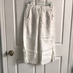 Linen Blend, Off White Wide Leg Pant. Side Pockets. Drawstring Waist. White Pull-on Style Bottoms For Vacation, White Mid-rise Capris For Summer, Casual White Bottoms With Frayed Hem, White Capris With Pockets For Vacation, Casual Cotton Capris For Day Out, Cotton Capris For Vacation In Spring, Casual Mid-rise Bottoms For Daywear, Spring Casual Daywear Capris, White Casual Capris For Vacation