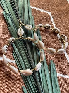 Elevate your beach vibes with our handcrafted cowrie shell hoop earrings. Each pair is meticulously crafted to exude bohemian charm and cultural elegance. These stunning earrings feature genuine cowrie shells delicately wire wrapped, creating a timeless accessory perfect for any occasion. Embrace your divine feminine energy with these versatile earrings, whether you're lounging by the shore or exploring the city streets. Add a touch of natural beauty to your look with these artisanal cowrie shel Trendy Gold Hoop Earrings For Beach, Bohemian Earrings With Ear Wire For Vacation, Beaded Hoop Jewelry For Beach, Beaded Hoop Jewelry For The Beach, Bohemian Drop Earrings For Vacation, Beach Wire Wrapped Drop Earrings, Trendy Hoop Earrings For Beach, Adjustable Hoop Earrings For Summer, Adjustable Nickel-free Hoop Earrings For Summer