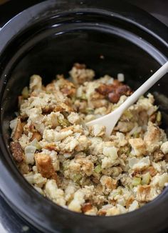 a crock pot filled with stuffing and vegetables