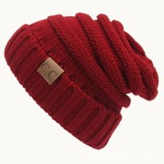 a red beanie hat is shown with a tag on it's front side