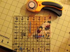 a pair of scissors sitting on top of a cutting mat