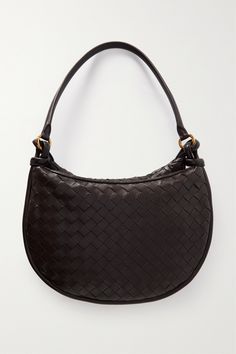 Find BOTTEGA VENETA Gemelli Medium Intrecciato Leather Shoulder Bag on Editorialist. Bottega Veneta's 'Gemelli' bag is defined by its crescent-shaped pouch that adds dimension to the curved design. It's crafted using the intrecciato weave first developed by the brand in the '60s to enhance the durability of leather. Thread your wrist through the top to carry it as a clutch. Luxury Brown Baguette Bag With Leather Handles, Classic Woven Leather Shoulder Bag For Shopping, Luxury Leather Baguette Bag With Leather Handles, Designer Baguette Bag With Leather Handles, Designer Woven Leather Clutch Shoulder Bag, Designer Leather Baguette Bag With Leather Handles, Designer Woven Leather Shoulder Bag For Evening, Elegant Top Handle Baguette Bag With Leather Handles, Brown Woven Leather Shoulder Bag For Office