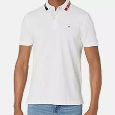 Description Features: A Classic In Every Sense Of The Word. This Tommy Hilfiger Polo Shirt Is A Casual Wardrobe Must-Have. Polo Shirt For Men Available In A Custom Fit. Polo Shirt Collar With A Two-Button Placket. Embroidered Flag At Chest On This Polo Shirt For Men. This Polo Shirt From Tommy Hilfiger Is Perfect For Any Casual Occasions. Product Details: A Classic In Every Sense Of The Word. This Tommy Hilfiger Polo Shirt Is A Casual Wardrobe Must-Have. Polo Shirt For Men Available In Tommy Hilfiger Fitted Casual Shirt, Fitted Casual Tommy Hilfiger Shirt, Tommy Hilfiger Classic Summer Tops, White Polo Shirt With Collared Neckline For Spring, White Collared T-shirt For Spring, Casual Fitted Tommy Hilfiger Polo Shirt, Fitted Tommy Hilfiger Casual Polo Shirt, White Casual Shirt With Collared Neckline, Casual White Shirt With Collared Neckline