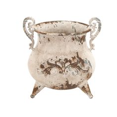 an old metal pot with ornate designs on it