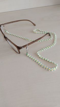 a pair of glasses with beads on the side and a lanyard attached to them