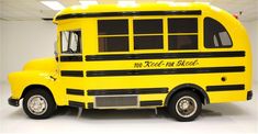 a yellow school bus is parked in a room with white walls and flooring that says no need on wheels