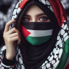 a woman wearing a scarf with the flag of united arab emirates on her face and covering her eyes