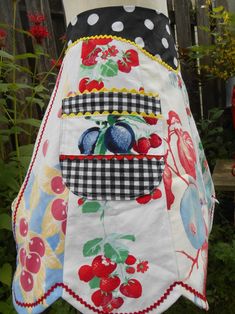 the apron is decorated with cherries and berries