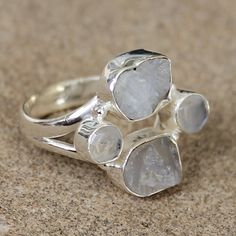 Looking for something really unique? This beautiful semi-precious natural rainbow Moonstone stone rough cut ring is set in 925 solid sterling silver. It has a gorgeous unique shape, perfect for dressing up or down. Stone: Rainbow Moonstone Cut: Rough Colour: White with Blue Shimmer Stone Size: Approx 1.5-2cm x 1.5-2cm Ring Band Size: Various Metal: Solid 925 Sterling Silver I love the raw beauty of rough cut semi-precious stones. Each stone is slightly different size and shape, as individual as Silver Sterling Moonstone Ring With Natural Stones, Silver Crystal Ring With Raw Stone, Silver Round Crystal Ring With Raw Stone, Sterling Silver Rings With Raw Stone, Silver Rings With Raw Stone, Green Onyx Stone, Moonstone Stone, Aquamarine Stone, Stone Studs