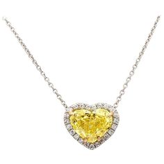 For sale is a lady's platinum and 18K yellow gold 2.12ct Fancy Vivid Yellow GIA Certified Heart shaped diamond necklace accented with 0.11 carats of round diamonds. CENTER STONE: 2.12ct FYV SI1 Heart Shaped Diamond ACCENT/SIDE STONES: 23 Round Brilliant Cut Diamonds (approx. 0.11ctw) METAL: Platinum, 18K Yellow Gold GRAMS: 1.4 SIZE: 16" LAB REPORT: GIA #2135870063 REFERENCE NUMBER: NK2795/FCX0022 Fancy Yellow Diamond Necklace, Luxury Yellow Gold Diamond Heart Necklace, Yellow Diamond Pendant, Heart Diamond Necklace, Heart Shaped Diamond Necklace, Yellow Diamond Necklace, Lab Report, Crayon Box, Fancy Yellow Diamond