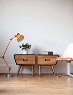 two wooden nightstands sitting next to each other on top of a hard wood floor