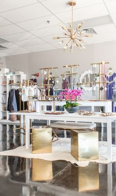 a room filled with lots of gold furniture and chandelier hanging from the ceiling