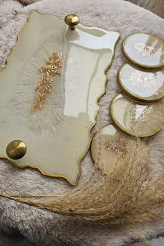 gold and white plates are arranged on a fur rug with golden accents, like feathers