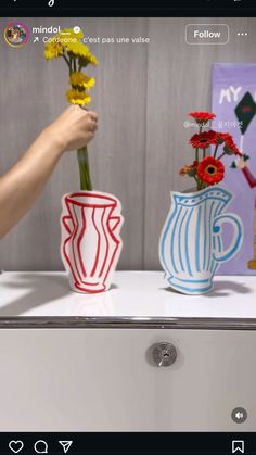 two vases that have flowers in them