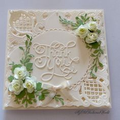 a wedding card with white flowers and greenery