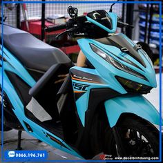 a blue motorcycle parked in front of a building