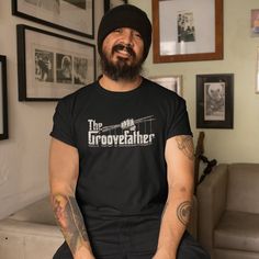 a bearded man wearing a black t - shirt with the words poop pop in the world on it