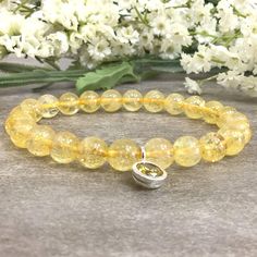 ✦Gemstone: Natural Citrine ✦Material: Sterling Silver CZ Charm ✦Color: Yellow ✦Shape: Round  ✦Length: 5''-9'' ✦Bead Size: 8mm  ✦QTY: 1 pcs / package ✦The 4mm and 6mm beads bracelet come with 6mm sterling sliver CZ charm.  ✦The 8mm and 10mm beads bracelet come with 8mm sterling silver CZ charm. ✦✦Please measure your wrist size, then order your bracelet. This bracelet makes the perfect gift for just about anyone in your friend or family circle. We have over 12 unique gemstone options to choose from. Please visit our store for more birthstones selection.  Citrine represents spiritual joy since it spreads positive, energetic light around its aura and is said to be one of only two crystals which do not need to be recharged or purified. Citrine can help facilitate prosperous occurrences all year Amber Crystal Bracelet With Gemstone Beads As Gift, Amber Gemstone Beads Crystal Bracelet As Gift, Yellow Crystal Bracelet With Gemstone Beads As Gift, Yellow Gemstone Beads Crystal Bracelet For Gift, Amber Crystal Bracelet With 8mm Beads As Gift, Yellow Citrine Crystal Bracelet Gift, Spiritual Beaded Birthstone Bracelets, Adjustable Citrine Bracelets, Amber Stretch Bracelet With 8mm Beads As Gift