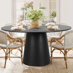 a dining table with chairs around it and a potted plant on the table top