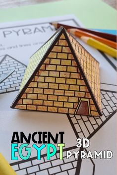 an ancient egypt pyramid made out of colored pencils on top of some construction paper