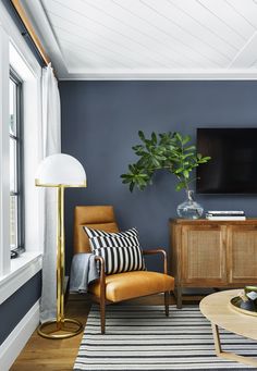 a living room with blue walls and wooden furniture