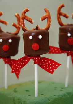 three chocolate reindeer lollipops on top of each other with bows and noses