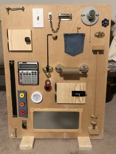 a wooden structure with various items attached to the wall and on top of it is a key board