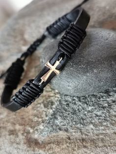 Unique men's leather bracelet with 14k yellow gold cross. Stylish guy gift. Gold jewelry for him. Designet with 6mm black Leather, 15mm lenght 14k yellow gold cross 0.50g and high quality black knitted thread. Hand crafted jewelry for men. Adjustable size, suitable for any wrist. Do not take a shower with your bracelet. Water can broke your bracelet. Ready to ship in 1-3 business days. Adjustable Black Jewelry For Father's Day, Masculine Black Jewelry For Gift, Minimalist Black Cross Jewelry, Black Spiritual Jewelry For Father's Day, Spiritual Black Jewelry For Father's Day, Modern Black Jewelry With Sliding Knot, Black Cross Pendant Jewelry For Father's Day, Black Cross Bracelet As Gift, Adjustable Black Cross Jewelry