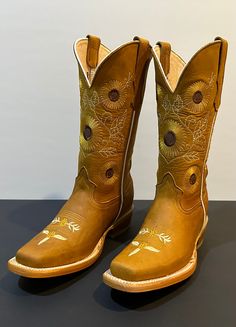 The Sunflower is built for durability with its Goodyear welt construction and leather sole. The unique stitching pattern, inspired by the flower itself, provides a striking visual aesthetic. From cowgirl to ranchers and any boot lover, the Sunflower is an ideal selection for anyone. **Here are just a few of the features that make the Sunflower so special:** All-leather Handcrafted construction Leather sole Beautiful stitching design pattern Durable and long-lasting Comfortable and stylish Country Style Hand Tooled Boots For Ranch, Country Style Hand-tooled Boots For Ranch, Goodyear Welt, Biker Boot, Western Boots, Leather Boots, Stitch Patterns, Sunflower, Pattern Design