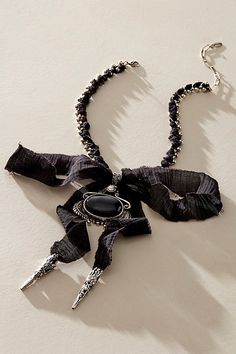 Add a head-turning touch to absolutely any look with this stand-out necklace featured in a textile-adorned chain design with defined pendant at center and exaggerated bow detail for an effortlessly edgy finishing touch. | Boca Bow Layer Necklace by Free People in Black Black Bow Jewelry For Evening, Adjustable Bow Jewelry For Evening, Black Jewelry With Ribbon For Evening, Black Ribbon Jewelry For Evening, Black Ribbon Necklace For Party, Elegant Black Jewelry With Bow Detail, Elegant Black Jewelry With Bow, Chic Adjustable Jewelry With Bow Detail, Chic Metal Jewelry With Bow Detail