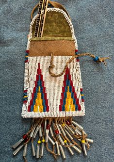 a small purse made out of beads and other items