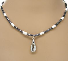 Black Glass White Puka Shells Necklace Silver Cowrie Shell Cowry Pendant Beach 18 Inches 7088-48 #18Inches #WomensNecklace #beach #BlackAndWhite #sup #surfer #VSCO #SeaShell #PukaShell #hematite Silver Beaded Jewelry For Vacation, Beach Silver Single Strand Necklace, Silver Single Strand Necklace For Beach, Silver Spacer Beads Jewelry For Beach, Beach White Silver Beaded Jewelry, Beaded Silver Strand Jewelry, Silver Single Strand Jewelry For Beach, Silver Round Beads Jewelry For Beach, Shells Necklace