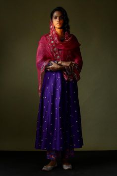 Purple silk anarkali with sequin and zari embroidery. Paired with a velvet embroidered jacket, printed pant and scallop trimmed embroidered pink dupatta.
Components: 4
Pattern: Embroidered
Type Of Work: Hand embroidery
Neckline: Round
Sleeve Type: Long
Fabric: Silk
Color: Purple
Other Details: 
Attached lining
Approx. product weight: 800 gms
Length:
Anarkali: 45 inches
Pant: 38 inches
Closure:
Pant: Elastic
Occasion: Mehendi and Haldi - Aza Fashions Festive Anarkali Sharara With Mirror Work, Chandbali Anarkali Set With Mirror Work For Reception, Transitional Traditional Maxi Length Wear, Festival Slub Silk Churidar With Mirror Work, Festivals Slub Silk Churidar With Mirror Work, Anarkali Style Dola Silk Sharara With Mirror Work, Mirror Work Anarkali Set For Reception, Slub Silk Traditional Wear With Dupatta For Eid, Traditional Drape Anarkali Set With Mirror Work For Reception