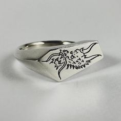 All “Ryujin” signet rings are made to order please allow 2-4 weeks production time. Ryujin the Japanese dragon god of the sea. Each design is hand carved by us and made using the "lost wax" technique. Carved, cast and finished in Australia. Material - Solid 100% Recycled Sterling Silver Face Size - 1.8 x 0.9cm Band tapers to 3.5mm Hallmarks -"DI" (Dead Ivy) & "925" (Sterling Silver) Gem Stone: 2mm lab grown Ruby or Blue Sapphire Unless requested gem stone will be flush set into same area as shown in product photos. Different placement and stones are available upon request. Men’s Rings, Japanese Tattoo Flash, Dragon God, Hand Carved Jewelry, Cool Rings For Men, Japanese Dragon, Signet Rings, Silver Signet Ring, Wax Casting