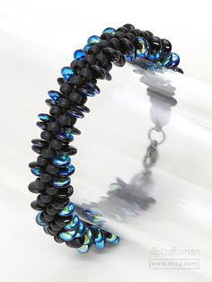 a black and blue beaded bracelet on a white background