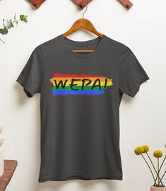 "WEPA! Express your Puerto Rican heritage and showcase your pride with this unique and meaningful unisex t-shirt. Whether you're attending a pride event, exploring your cultural roots, or simply adding a vibrant touch to your everyday outfits, this shirt is a statement piece that will make heads turn and spread joy wherever you go.  Available in a range of sizes, our Rainbow \"WEPA!\" T-Shirt is designed to fit all genders comfortably. It also makes a thoughtful gift for your Puerto Rican friends, family, or loved ones who appreciate colorful expressions of identity and heritage. \"WEPA!\" is not just a word but a contagious feeling of excitement and celebration. Add this joyful t-shirt to your collection today and let your vibrant spirit shine through! .: 100% Airlume combed and ringspun Pre-shrunk Crew Neck T-shirt For Pride, Cotton Slogan T-shirt For Pride, Pride Graphic Tee With Screen Print, Pride Short Sleeve T-shirt With Letter Print, Pride Graphic Tee With Slogan, Pride Letter Print Short Sleeve T-shirt, Pride Screen Print Crew Neck T-shirt, Pride Graphic Tee With Letter Print, Pride Cotton Crew Neck T-shirt