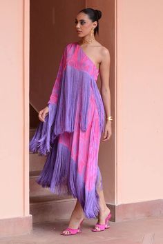 Lilac, pink one shoulder dress with wave print and fringe tassel embroidery.
Components: 1
Pattern: Printed, Embroidery
Type Of Work: Wave, Fringe Tassel
Neckline: Asymmetric
Sleeve Type: One shoulder sleeve
Fabric: Crepe
Color: Purple,Pink
Other Details: 
Tassel fringe
Occasion: Party - Aza Fashions Bohemian Dresses With Traditional Drape For Summer, Bohemian Summer Dresses With Traditional Drape, Pink Traditional Drape Dress For Spring, Festive Floor-length Dress With Tassels, Traditional Pink Dress For Spring, Pink Spring Dress With Traditional Drape, Festive Maxi Dress With Tassels, Festive Tassel Maxi Dress, Festive Bohemian Dresses With Tassels